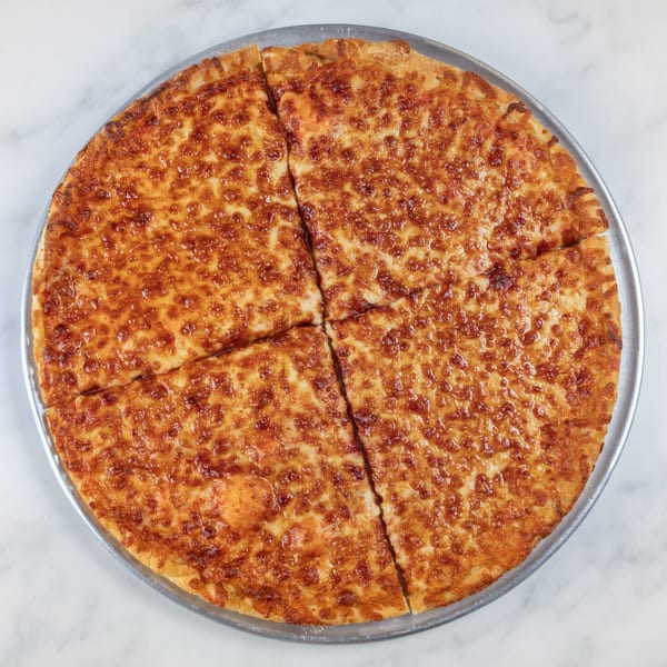 A whole cheese pizza, cut into four slices, on a metal pan.