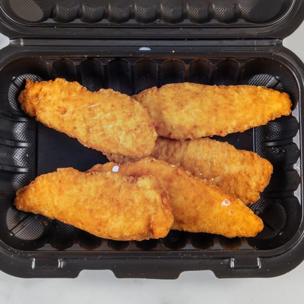 Five golden-brown chicken tenders or fish fillets in a black takeout container from Apollon Roast Beef & Pizza.